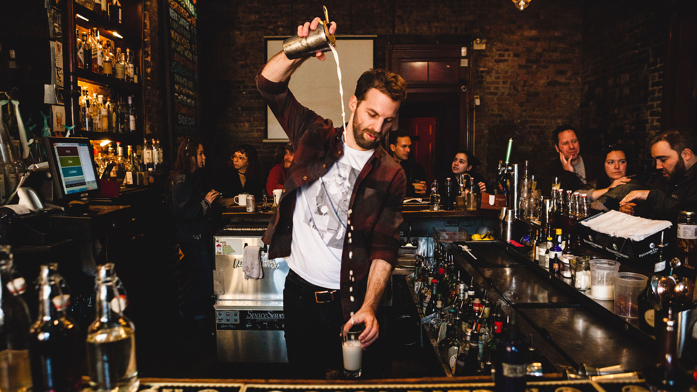 A tall, frothy gin fizz cocktail freshly poured